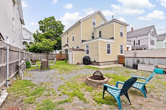 93 Warren, Fall River, MA 02721 - back of property with an outdoor fire pit, a fenced backyard, and outdoor dining space