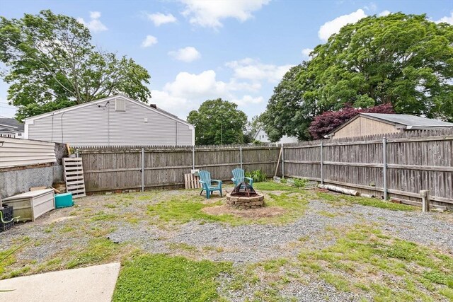 93 Warren, Fall River, MA 02721 - fenced backyard featuring an outdoor fire pit