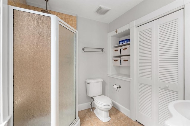 bathroom with visible vents, toilet, a closet, and a shower stall