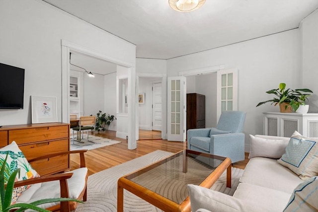 living area with french doors and light wood finished floors
