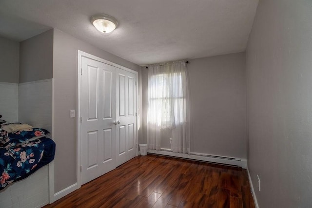 272 S Precinct, Taunton, MA 02718 - unfurnished bedroom featuring baseboard heating, baseboards, and wood finished floors