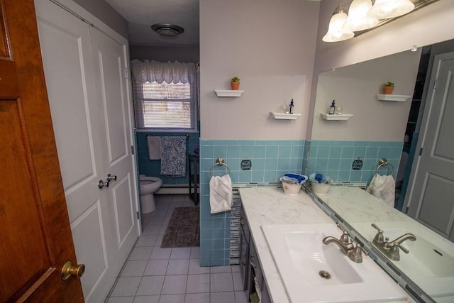 272 S Precinct, Taunton, MA 02718 - bathroom featuring vanity, a baseboard heating unit, tile patterned flooring, toilet, and wainscoting