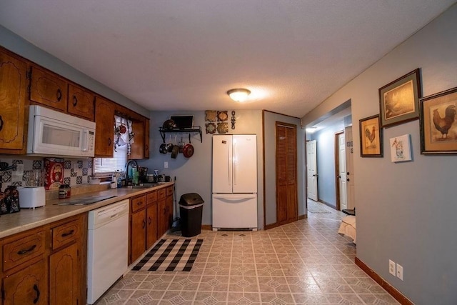 272 S Precinct, Taunton, MA 02718 - kitchen featuring white appliances, light countertops, brown cabinets, light floors, and a sink