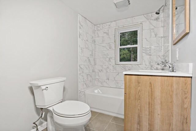 full bathroom with tiled shower / bath, vanity, toilet, and tile patterned flooring