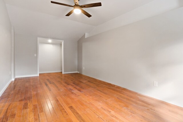 spare room with ceiling fan, vaulted ceiling, and hardwood / wood-style floors