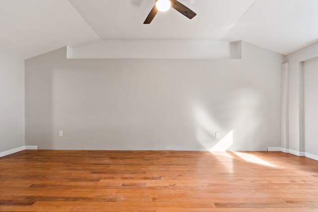 unfurnished room featuring light hardwood / wood-style floors, ceiling fan, and vaulted ceiling