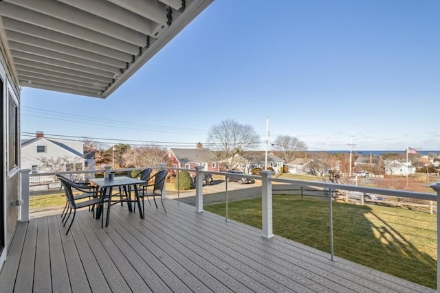 wooden deck featuring a lawn