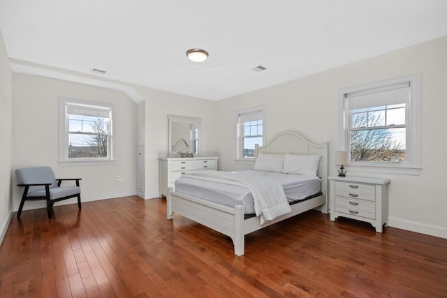 bedroom featuring dark hardwood / wood-style floors and multiple windows