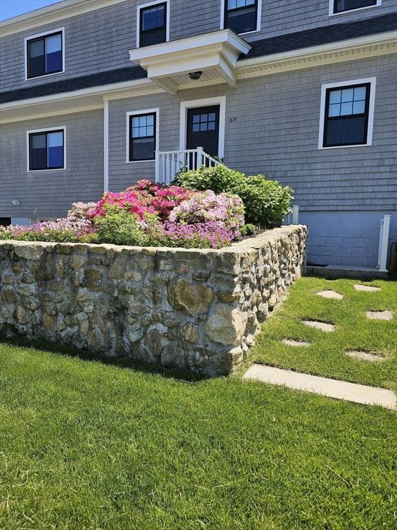 view of exterior entry featuring a lawn