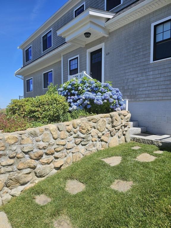 view of exterior entry featuring a yard