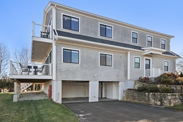 view of front facade with a garage, a carport, and a wooden deck