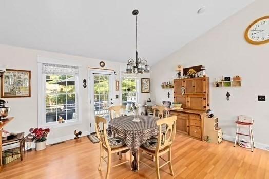 544 Lunns Way, Plymouth, MA 02360 - dining space featuring lofted ceiling, light wood-style floors, and a chandelier