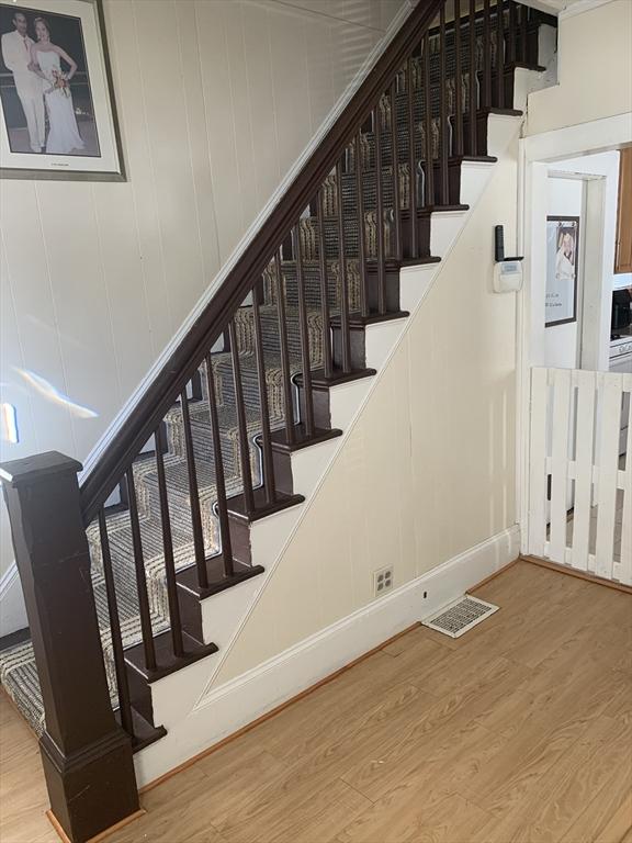 staircase featuring hardwood / wood-style floors