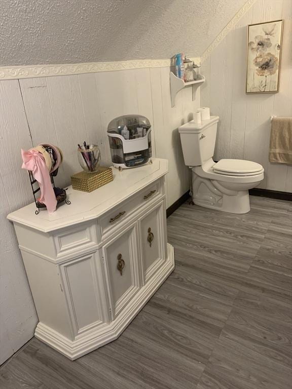 bathroom featuring hardwood / wood-style floors and toilet