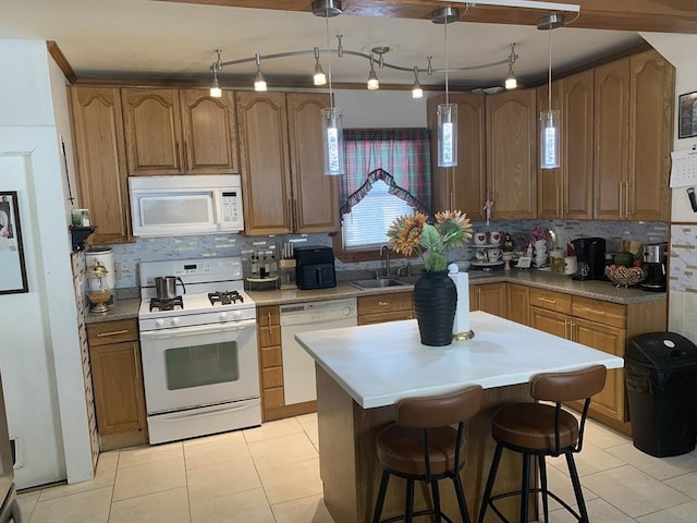 kitchen with backsplash, sink, white appliances, and light tile patterned floors