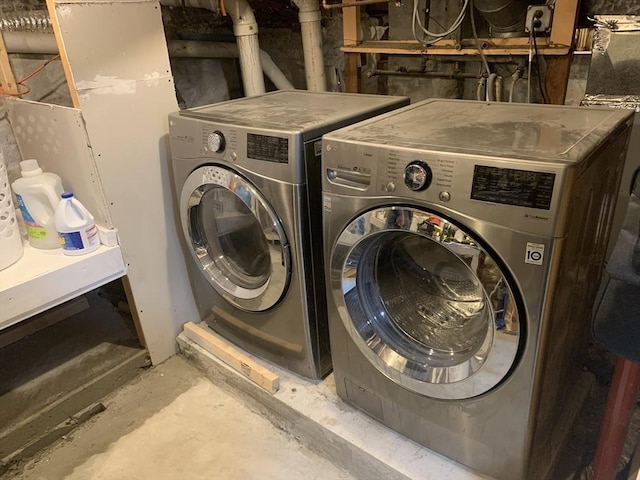 clothes washing area with washer and clothes dryer