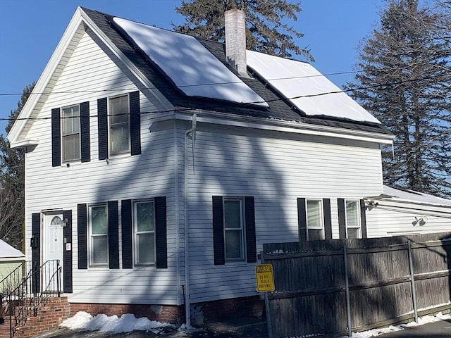 view of side of property with solar panels