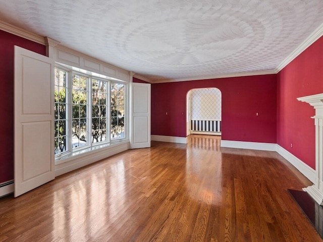 spare room featuring ornamental molding and wood-type flooring