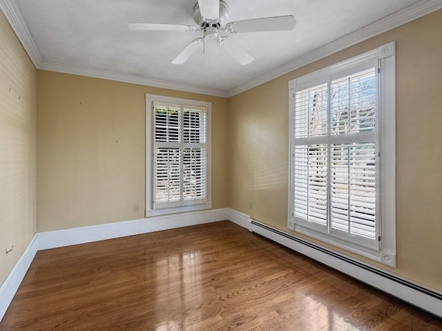 spare room featuring hardwood / wood-style flooring, ornamental molding, ceiling fan, and baseboard heating