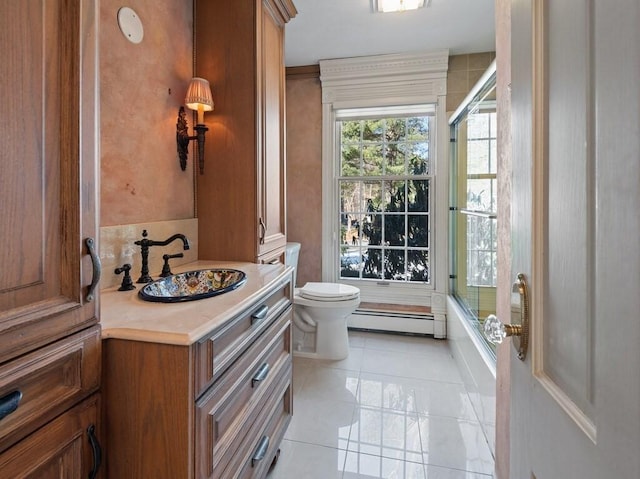 full bathroom with toilet, shower / bath combination with glass door, a baseboard radiator, vanity, and tile patterned flooring