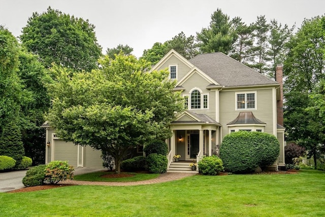 3 Aaron Rd, Lexington, MA 02421 - view of front of home featuring a front lawn, a chimney, driveway, a garage, and a porch