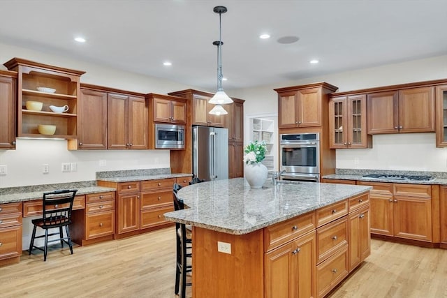3 Aaron Rd, Lexington, MA 02421 - kitchen featuring appliances with stainless steel finishes, a breakfast bar area, light wood-type flooring, a kitchen island, and recessed lighting