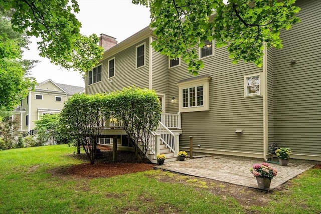 3 Aaron Rd, Lexington, MA 02421 - rear view of house with a lawn, stairway, a patio area, a chimney, and a deck