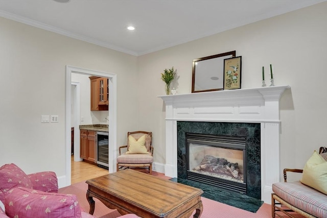 3 Aaron Rd, Lexington, MA 02421 - living area with a dry bar, wine cooler, ornamental molding, recessed lighting, and a fireplace