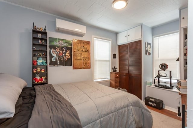 bedroom with a closet and a wall mounted AC