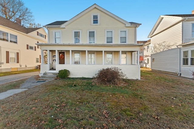 view of front of house featuring a front yard and covered porch