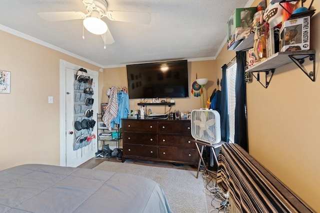 bedroom with carpet flooring, ornamental molding, and ceiling fan