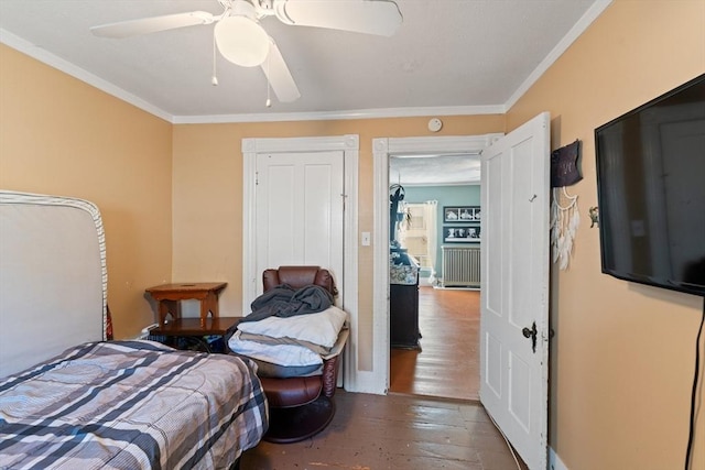 bedroom with wood finished floors, ceiling fan, and ornamental molding