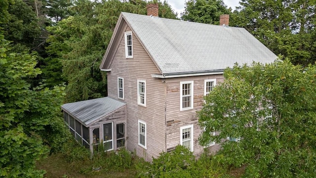 view of side of home with a sunroom