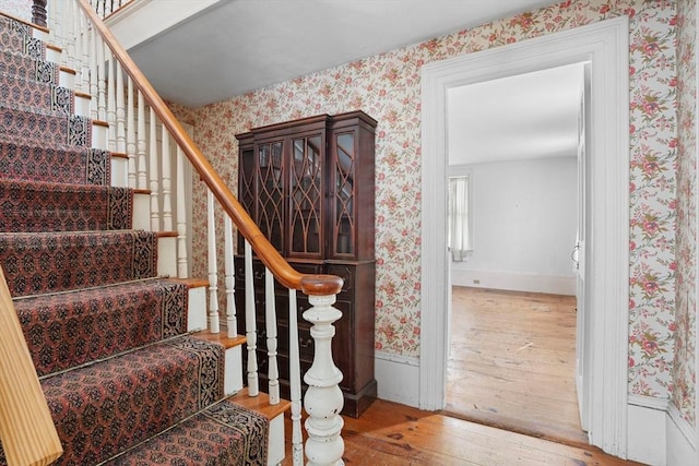 staircase with hardwood / wood-style floors