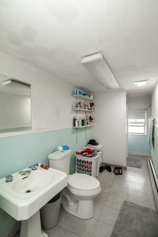 bathroom with tile patterned flooring, a baseboard radiator, an enclosed shower, and toilet