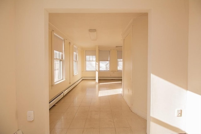 hallway with light tile patterned floors and a baseboard radiator