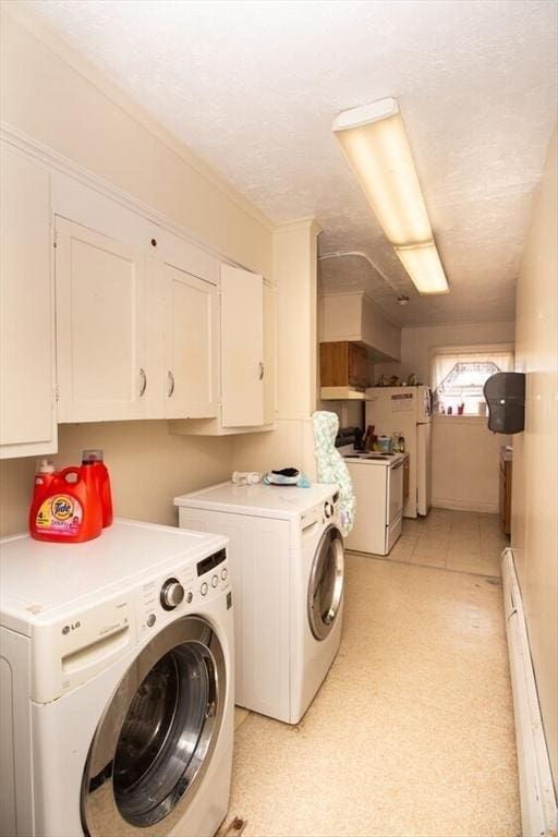 laundry room with cabinets, a textured ceiling, separate washer and dryer, and baseboard heating