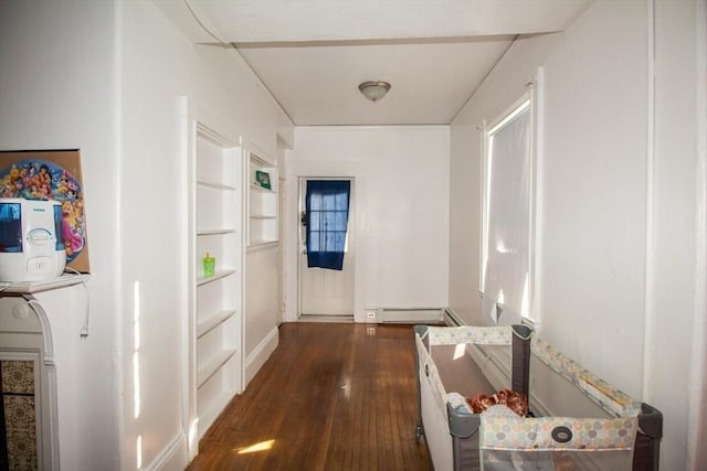 hallway with dark hardwood / wood-style floors and a baseboard radiator