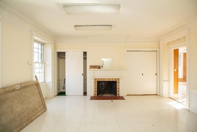 unfurnished living room featuring a premium fireplace and crown molding