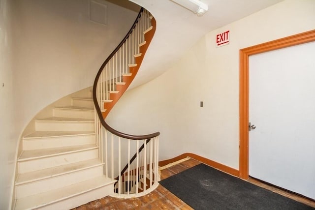 staircase featuring wood-type flooring