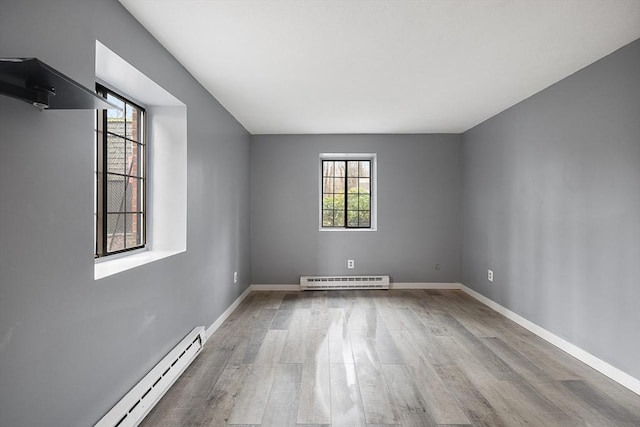 spare room featuring light hardwood / wood-style flooring and a baseboard radiator