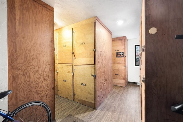 corridor with light hardwood / wood-style flooring