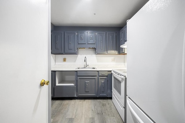 kitchen featuring white appliances, gray cabinets, light hardwood / wood-style flooring, and sink