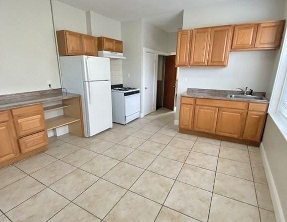 125-129 Arlington St, Chelsea, MA 02150 - kitchen featuring light tile patterned floors, white appliances, under cabinet range hood, a sink, and baseboards