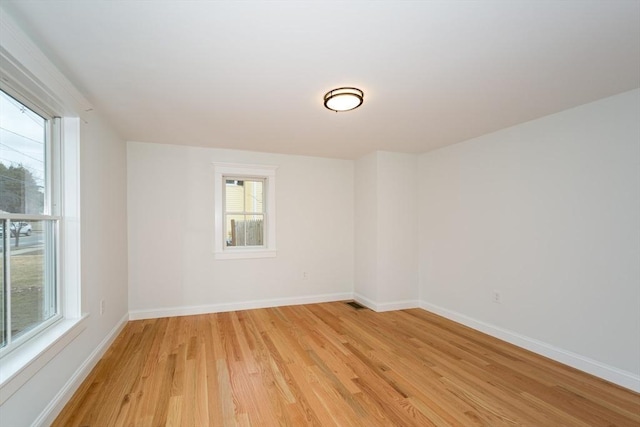 unfurnished room featuring light wood-type flooring and baseboards