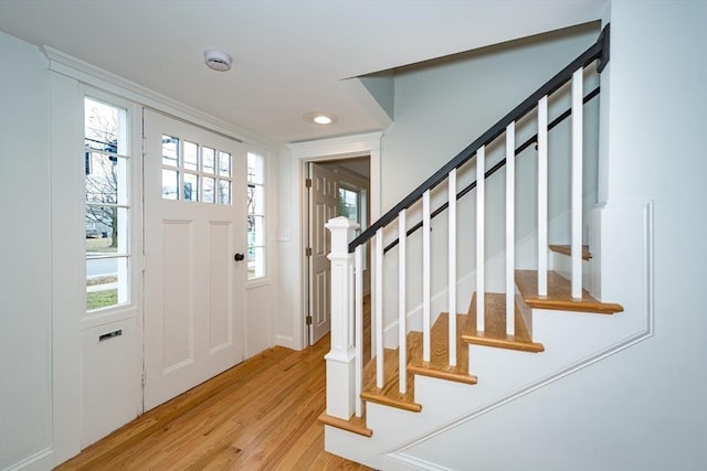 entrance foyer with light wood-style floors, stairs, and recessed lighting