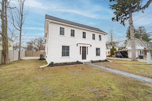 colonial inspired home with central AC, a front yard, and fence