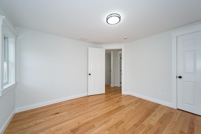 spare room with light wood finished floors and baseboards