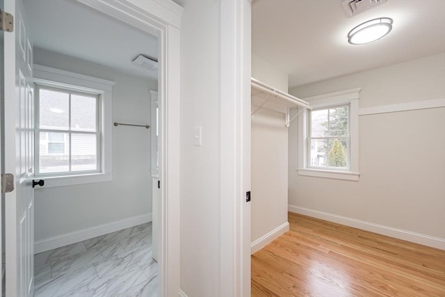 walk in closet featuring marble finish floor and visible vents