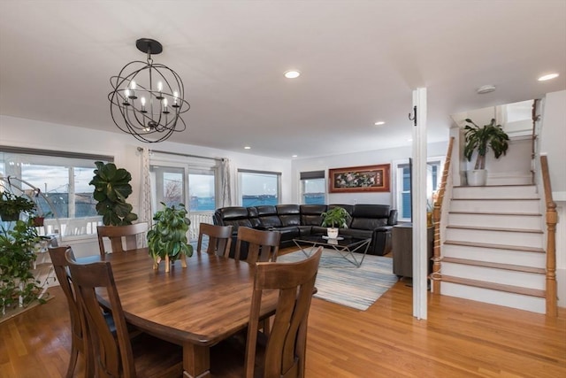 dining area featuring light wood-type flooring and a chandelier